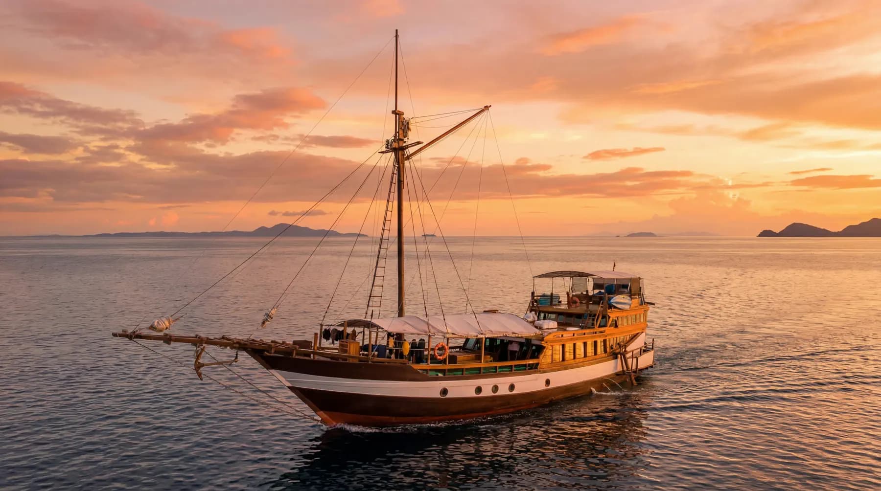 Wellenreng traditional wooden sailing vessel cruising calm water with a single tall mast at sunset